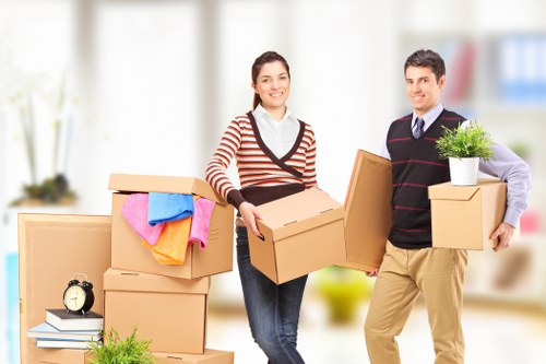House moving truck and packed boxes in a residential Harold Wood street