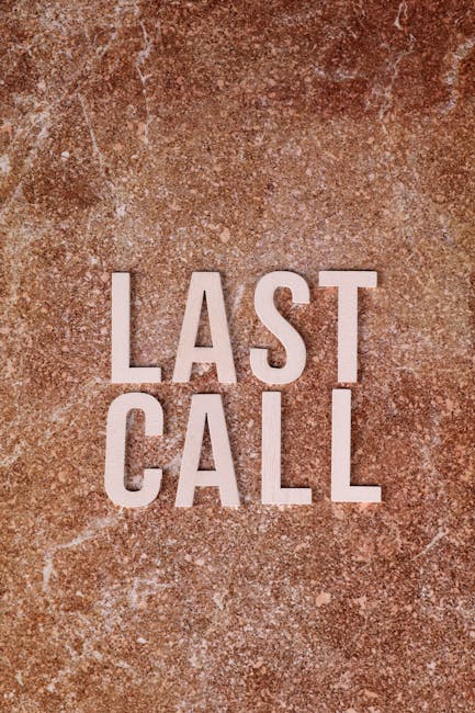 The image displays a close-up of a textured, rust-colored surface, possibly metal or stone, with the words 'LAST CALL' prominently written in large, white, capital letters. The background features a mottled appearance with variations in coloration and a slightly gritty texture. The phrase 'LAST CALL' is centered and clearly visible, emphasizing an urgent or final notification. Although the image does not explicitly depict any furniture, packaging, or moving equipment, the phrase can subtly relate to the final step in a home relocation or moving process, such as the last opportunity to pack or finalize arrangements before completion. This visual could be associated with the concept of concluding a house removal or packing and moving activities managed by companies like Man with Van Harold Wood, especially in the context of last-minute or same-day moves, as suggested by the page titled 'Same-day Harold Wood removals for last-minute tenancy ends.'